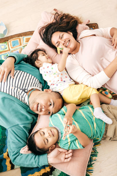 Happy family time Family of four at home having fun happy filipino family stock pictures, royalty-free photos & images