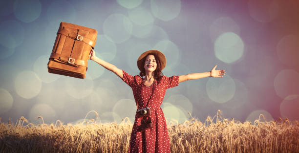 young woman with camera and suitcase