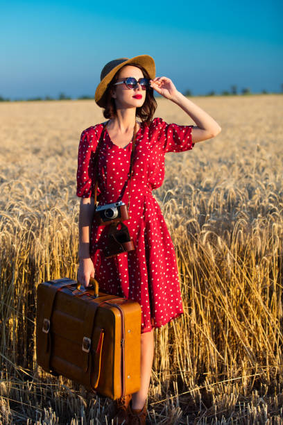 istock young woman with camera and suitcase 688307840