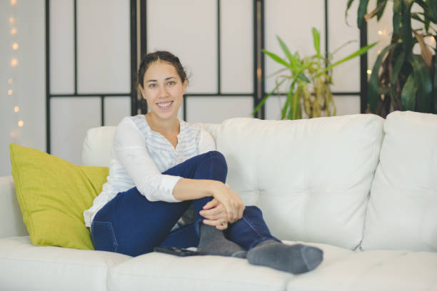 istock Beautiful young ethnic woman relaxing contentedly on couch 688307906