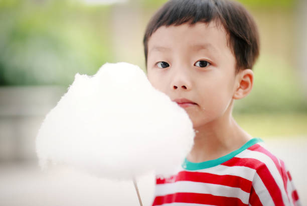 istock Child Eating Candyfloss or Cotton Candy 688311332