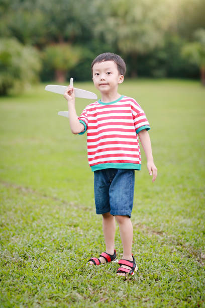 istock Boy hand holding a paper plane 688315336