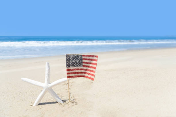 istock Patriotic USA background with starfish on the sandy beach 688332230