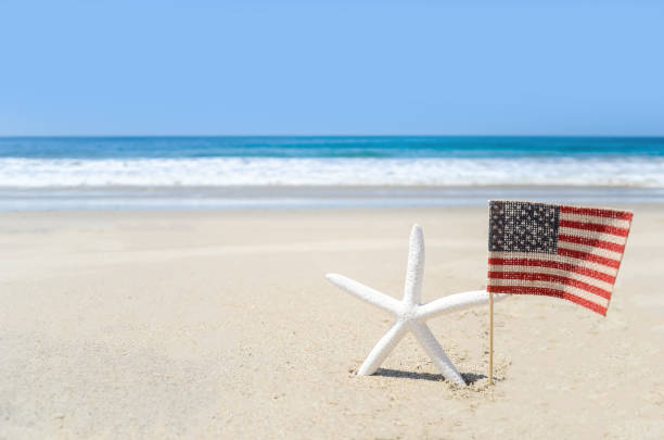 istock Patriotic USA background with starfish on the sandy beach 688332260