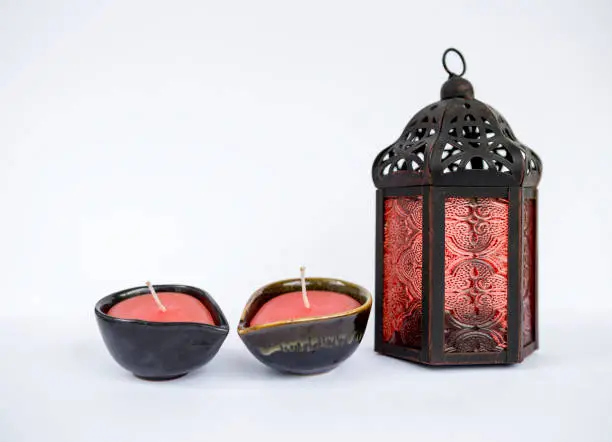 Photo of Metal and red glass vintage lantern with red candle