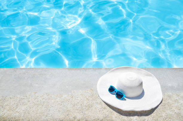 istock Summer hat and sunglasses near the pool 688338042