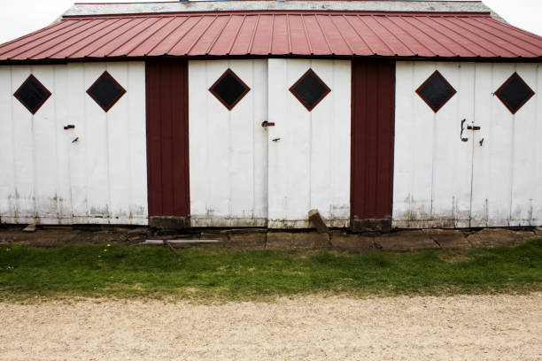 Red garage with row of double white doors