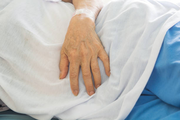istock old Hand women on bed patient 688341704