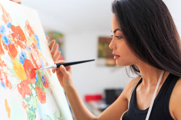 istock Female artist working in art studio 688348408