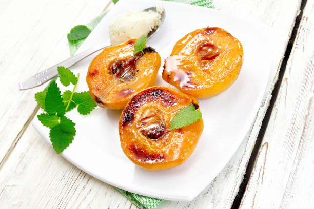 istock Quince baked with ice-cream and mint in plate on light board 688358866