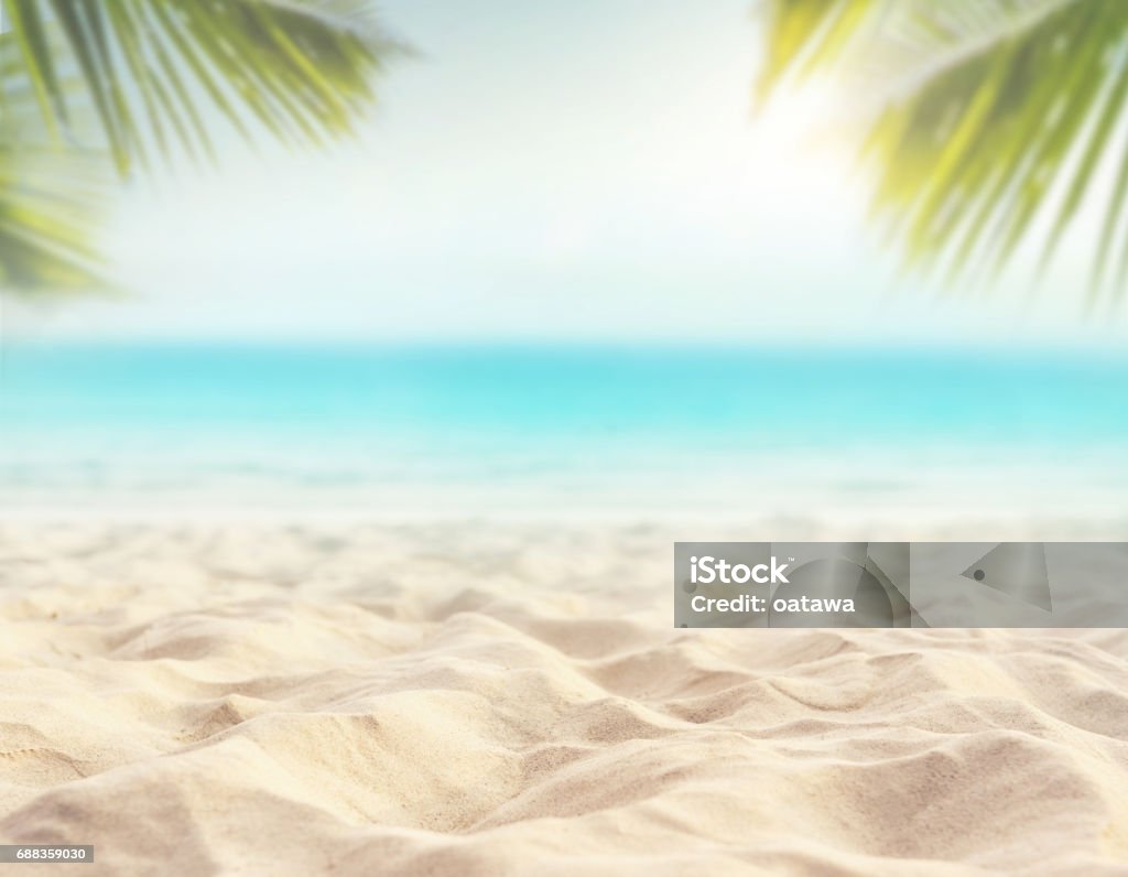 sand with blurred sea sky background, summer day Close up sand with blurred sea sky and plam leaf background, summer day, copy space or for product. Beach Stock Photo