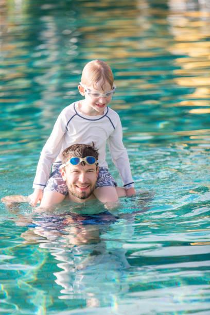 istock family in the pool 688361436