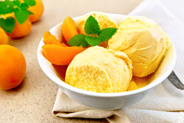 istock Ice cream apricot in bowl on napkin 688362152