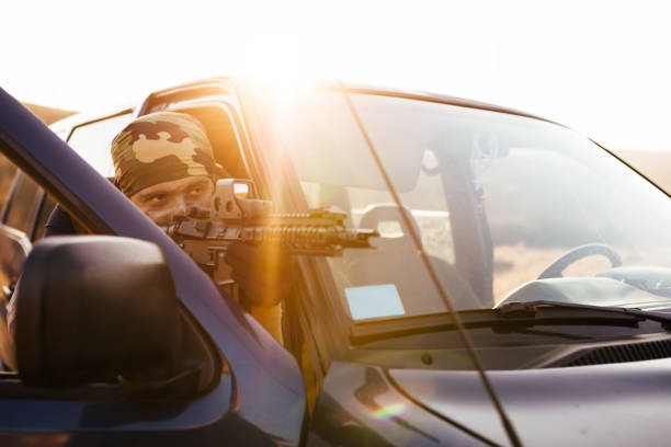 istock Soldier covered behing car door 688362490