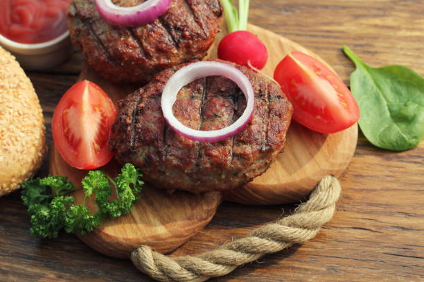istock Homemade beef burger with onion on cutting board 688362516