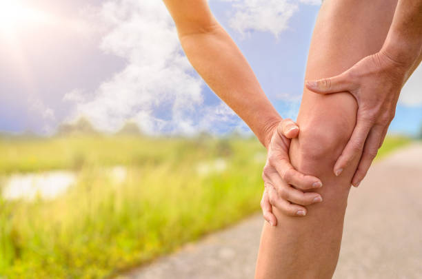 istock Woman Holding her Injured Knee 688372844
