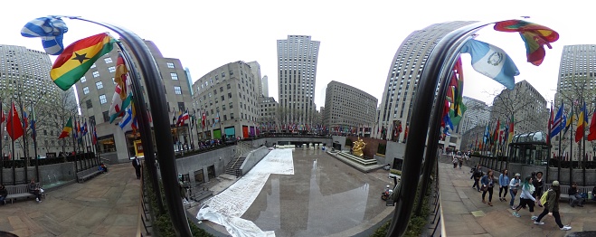 New York City, United States - April 19, 2017:  World's flags fly at Rockefeller Plaza in Midtown Manhatten, New York City, United States.The image was taken with a 360 camera