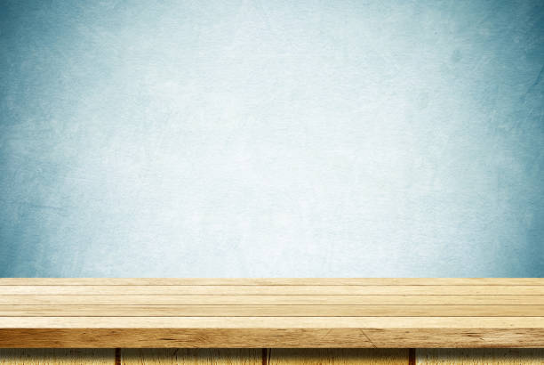 istock Empty wooden table over blue cement wall  background, for product display montage 688375228