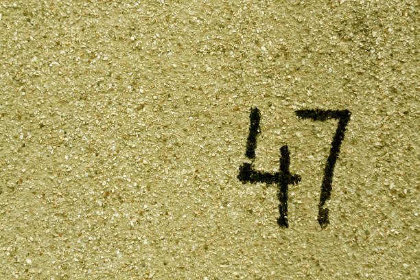 istock number fourty seven on yellow plaster wall. 688376338