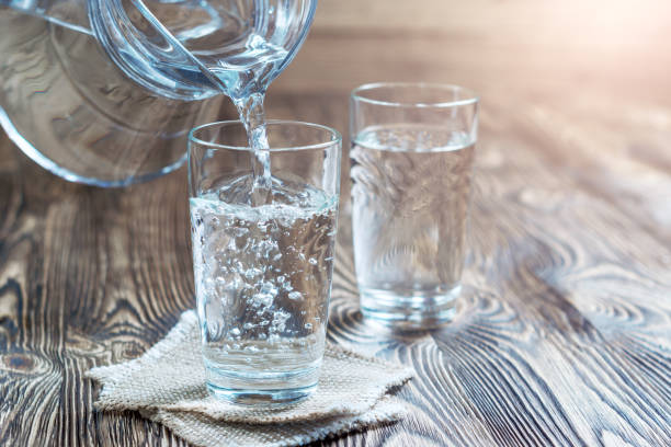 istock Glass of water on a wooden table 688376514