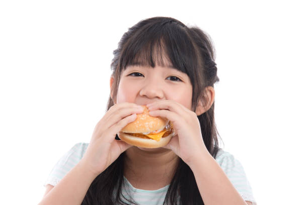 istock Beautiful asian girl eating hamburger 688376812