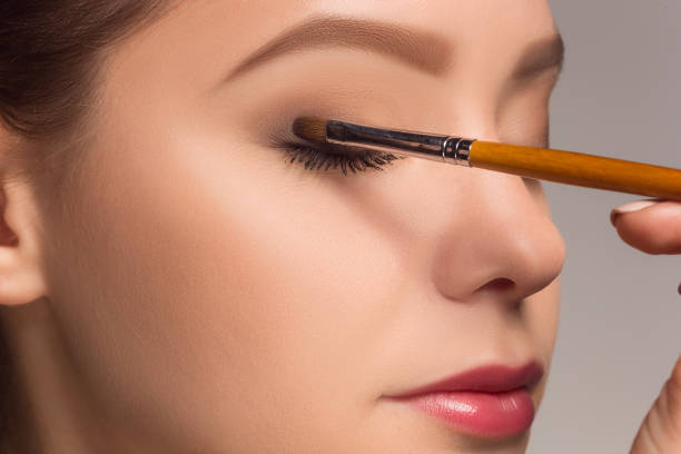 istock Beautiful female eyes with make-up and brush 688384322