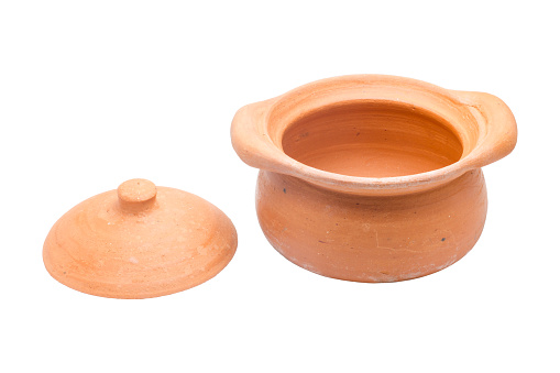 The pot and lid are placed on the floor. Made of brown pottery isolated on white background,with clipping path
