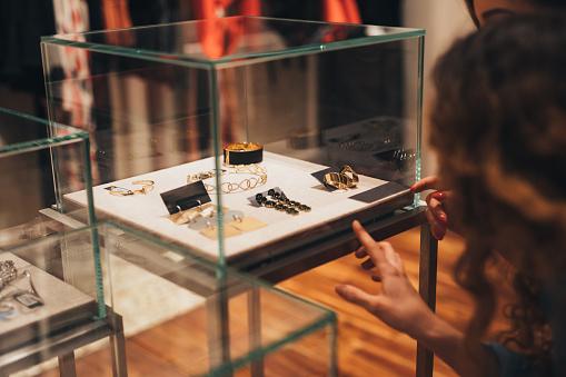 Friends looking at some jewelry in a store.