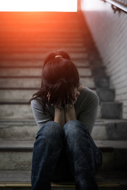 istock depressed woman in underground 688401392