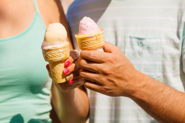 istock Man and woman holding two ice cream 688403652