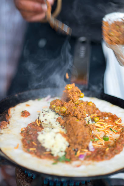 istock Filled Indian Dosa Cooking on Hot Skillet 688403776