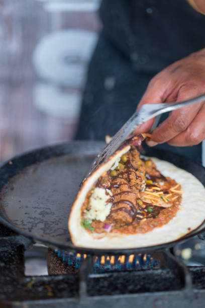 istock Folding Dosa While Cooking on a Hot Skillet 688403804