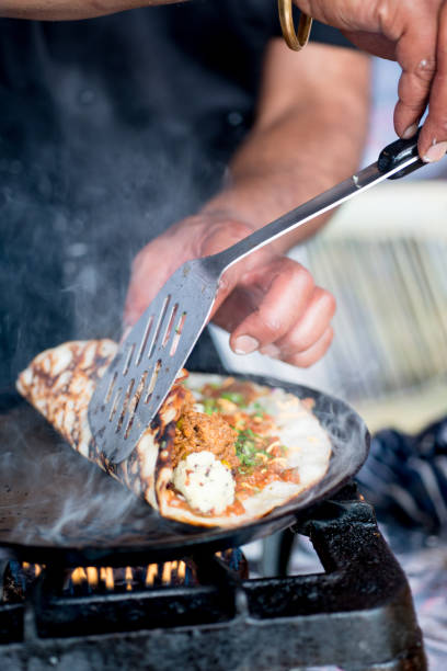istock Indian Dosa Being Rolled with a Spatula on Hot Skillet 688403832