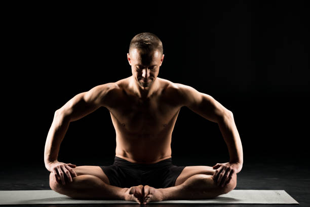 istock Man sitting in yoga position 688403924