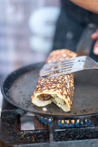istock Rolled Dosa Cooking on a Hot Skillet 688403956