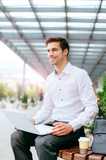 istock Businessman in financial district working on laptop 688403986