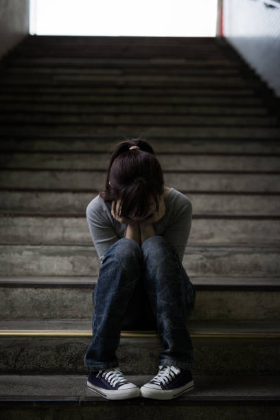 istock depressed woman in underground 688404186