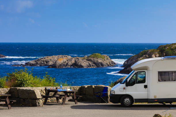 istock Camper car on coast of Norway with ocean view 688404462