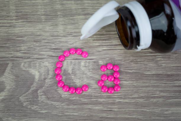 istock Pink pills forming shape to Ca alphabet on wood background 688404482