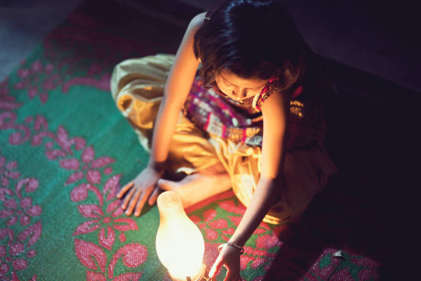 istock Girl sitting on carpet with lamp 688406748