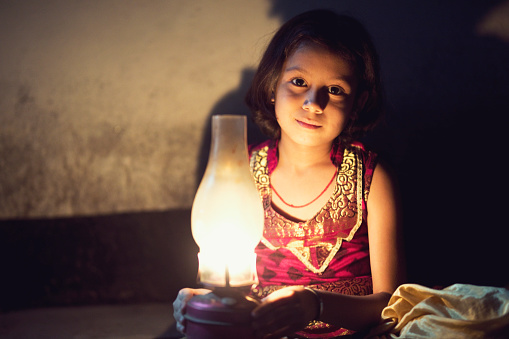Portrait of Indian girl holding oil lamp