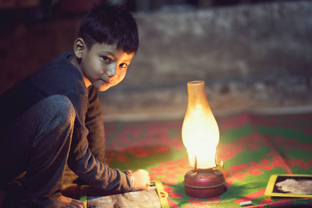istock Boy studying in oil lamp 688406902