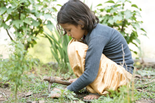 istock Girl with gardening hoe 688407414
