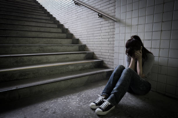 istock depressed woman in underground 688407834