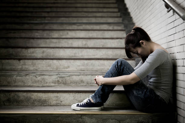 istock depressed woman in underground 688410284