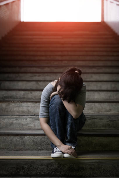 istock depressed woman in underground 688410606