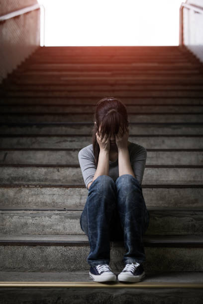 istock depressed woman in underground 688410672
