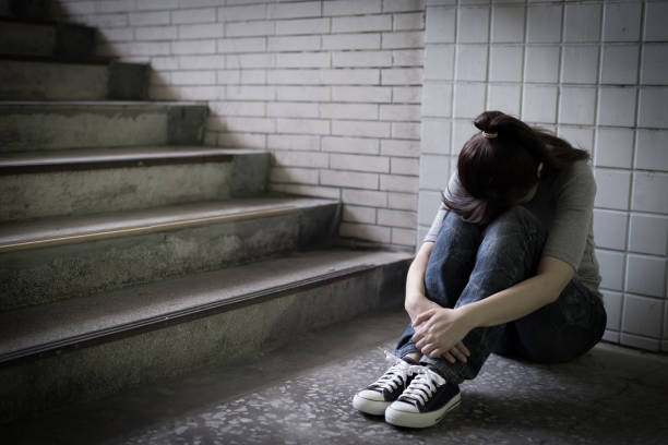 istock depressed woman in underground 688411094