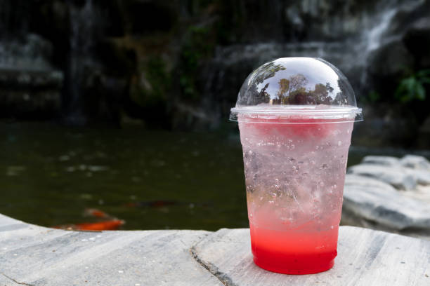 strawberry italian soda with ice on stone floor