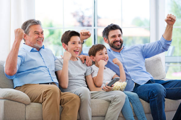 istock Family watching football match on telly 688438552